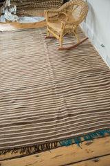 Vintage Moroccan Kilim rug end with knotted aqua blue and black fringe.