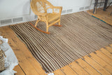 Striped ivory and brown flatweave of the vintage Moroccan Kilim, showing turquoise selvedge.