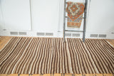 Vintage Moroccan Kilim rug featuring natural undyed ivory and brown striated weaving.