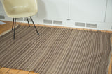Striated weaving texture of natural brown and grey stripes on a vintage Moroccan Kilim, circa 1970s.