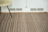 Striated natural coffee, charcoal brown, and grey stripes on a vintage Moroccan Kilim rug.