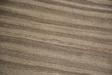 Striated natural light coffee and charcoal brown flatweave wool texture on a vintage Moroccan Kilim.