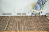 Hand-woven vintage Moroccan Kilim rug with striated browns, ivory, and green tones.