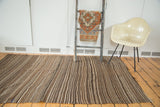 Vintage Moroccan Kilim flatweave, rhythmic brown, beige, and dark striped weaving with blue detail.