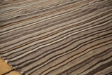 Moroccan Kilim rug featuring striated flatweave texture in natural brown and coffee tones.