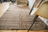 Moroccan Kilim rug with natural striated stripes in brown and silver tones, secured end.