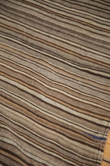 Striated natural silver, coffee, brown, and royal blue striped vintage Moroccan Kilim detail.