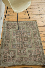 Vintage Oushak rug with geometric germinating flowers, dusty blush and soft green tones.