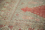 Distressed texture of vintage Oushak prayer rug with muted cinnabar and sand patterns.