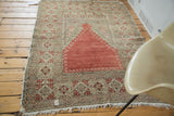 Distressed vintage Oushak Prayer rug corner, cinnabar field, beige border with tatter and fringe.