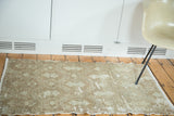 Distressed vintage Turkish Oushak rug, faded celadon and brown lattice pattern.