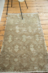 Distressed celadon and natural brown shadow design on vintage Oushak rug with visible foundation.