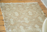 Distressed Oushak rug, showing shadow design in faded celadon and visible foundation.