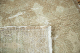 Distressed vintage Oushak rug pile with faded celadon, natural brown foundation, and fringe.