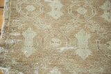 Faded celadon and brown hues on the distressed pile of a vintage Oushak rug.