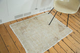 Lightly distressed vintage Oushak rug, blanched ivory with subtle coffee corner spandrels.