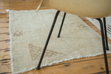 Distressed vintage Oushak rug texture with blanched pile and subtle light coffee corner patterns.