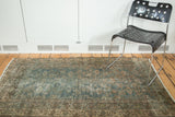 Heavily distressed Malayer rug with faded forest green herati design and blush tones.