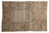 Distressed vintage Oushak Prayer rug featuring a stepped mehrab design in bronze, blush, and brown, 3'2