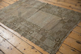 Distressed vintage Oushak prayer rug, showcasing faded bronze and blush stepped mehrab design.