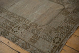 Geometric border patterns and localized wear on a distressed vintage Oushak Prayer rug corner.
