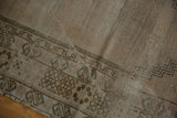Geometric stepped border and exposed foundation of a distressed Oushak rug.