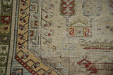 Close-up of the vintage Oushak rug's unique faded coloration and distressed pile texture.