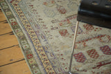 Faded moss green and saffron yellow border on a distressed vintage Oushak rug.