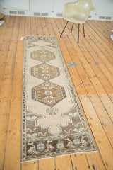 Ornate medallion and mehrab pattern on a vintage Oushak runner in bronze, charcoal, faded apricot, sea foam green.