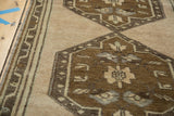 Ornate bronze medallion and faded apricot hues on Turkish Oushak runner's leaf border.