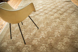Vintage Oushak carpet corner with repeating floral design, lattice panels, and subtle abrashes.
