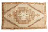 Vintage Oushak carpet with oversize medallion and tribal design in soft brown and ivory tones, 6'2