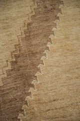 Ivory and soft brown stepped tribal pattern on a vintage Oushak carpet.