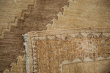 Hand-knotted vintage Oushak rug corner, revealing tribal pattern, ivory fringe, and soft bronze tones.