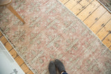 Distressed vintage Oushak runner, faded blush quatrefoil pattern, exposed foundation.