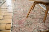 Vintage Oushak rug runner with distressed pile, showcasing faded blush and ivory quatrefoil floral motifs.