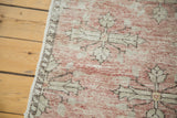 Evenly distressed texture and faded blush quatrefoil motifs on a vintage Oushak rug runner.
