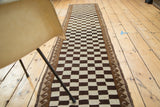 Natural ivory and dark brown geometric checkerboard pattern with a wave motif border.