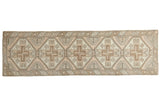 Vintage Oushak runner with tribal geometric medallions in faded blush, sand, and brown.