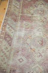 Distressed vintage Oushak runner, highlighting exposed foundation and faded eggplant green tones.