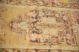 Distressed Oushak rug featuring visible holes, frayed pile, saffron and beige pattern.