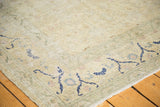 Distressed low-pile texture of a vintage Sivas carpet with cobalt blue details on its ivory ground.