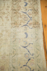 Worn texture and low pile of a distressed Sivas carpet with cobalt blue floral details.