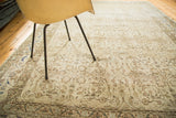 Time-softened pile and distressed floral patterns on a vintage ivory Sivas carpet.