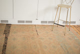 Vintage Turkish Jijim rug featuring pink and gray geometric patterns and a black streak.