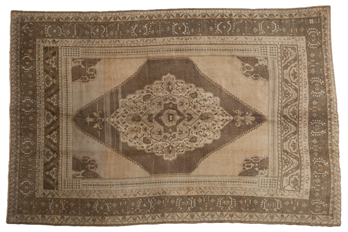 Vintage Distressed Oushak carpet, ornate oblong medallion, natural brown, faded sand, dragon border, 6'7" x 10'.
