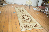 Vintage Oushak runner's bold chocolate brown double medallion design and abrash details.