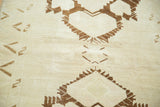Chocolate brown geometric motifs against faded ivory and light coffee tones.