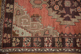 Vintage Oushak rug detail: cinnabar field meets serrated beige spandrel and chocolate border.