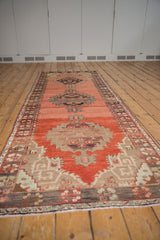 Vintage Oushak runner's dark chocolate border with floral bouquets and meandering minor border.